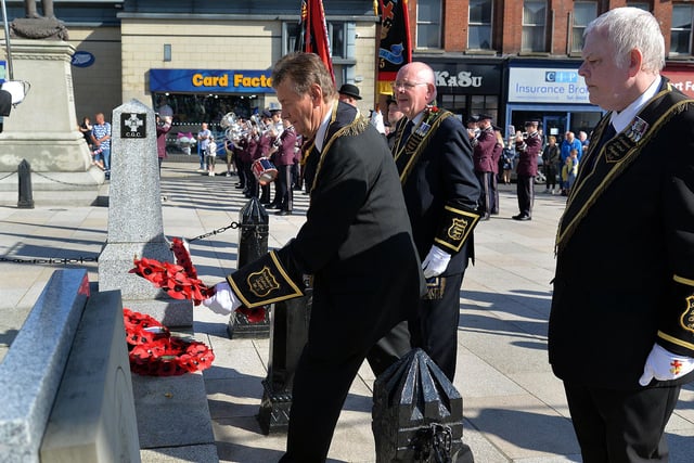 Worshipful District Master, Sir Knight Raymond Walker lays a wreath at the war memorial at the beginning of the Portadown Thirteenth parade. PT28-315.