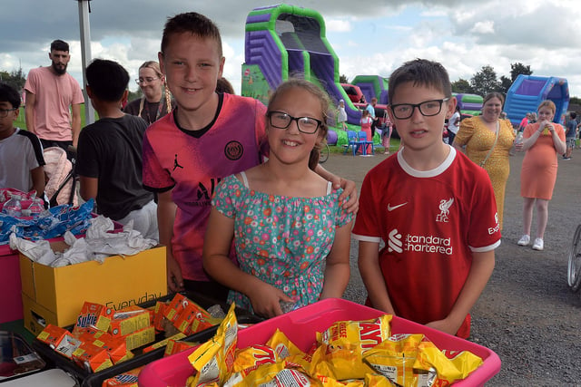 Deciding what to buy at the St John the Baptist's College fun day tuck shop are from left, Harry Griffin, Saoirse Matchett and Caolin Griffin. PT37-214.