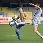 Coleraine’s Josh Carson and Newry’s Brian Healy battle for possession. Pictures: INPHO/Stephen Hamilton