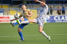 Coleraine’s Josh Carson and Newry’s Brian Healy battle for possession. Pictures: INPHO/Stephen Hamilton