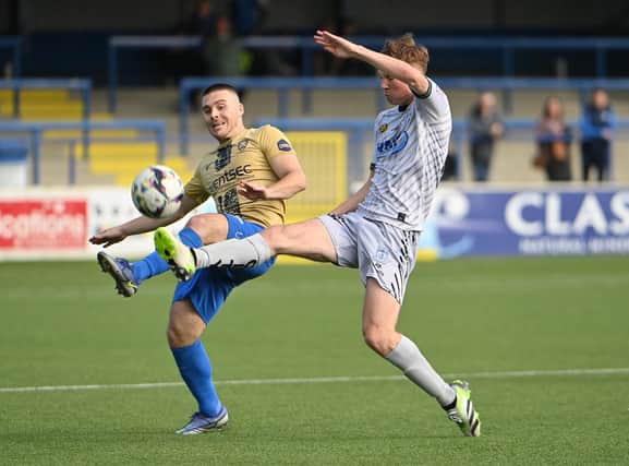 Coleraine’s Josh Carson and Newry’s Brian Healy battle for possession. Pictures: INPHO/Stephen Hamilton