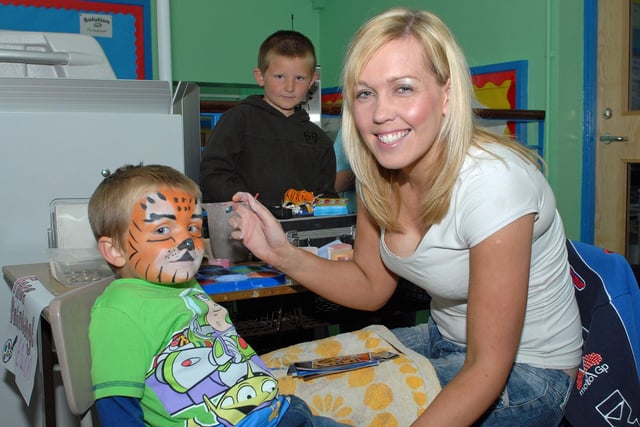 Pauline paints Ewan's face at the Ballycarry Primary School summer fair in 2012. INLT 25-016-PSB