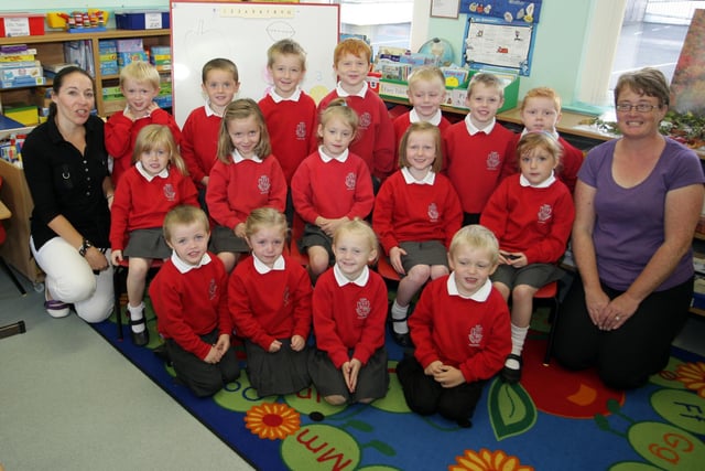 Eden PS P1's smile for our photographer in 2010 along with Teacher Mrs Kerry Suitter (left) and Classroom Assistant Mrs Ann Hall.