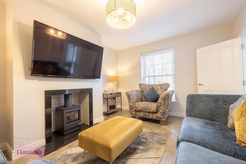The spacious lounge with gas stove, granite hearth and tiled area.