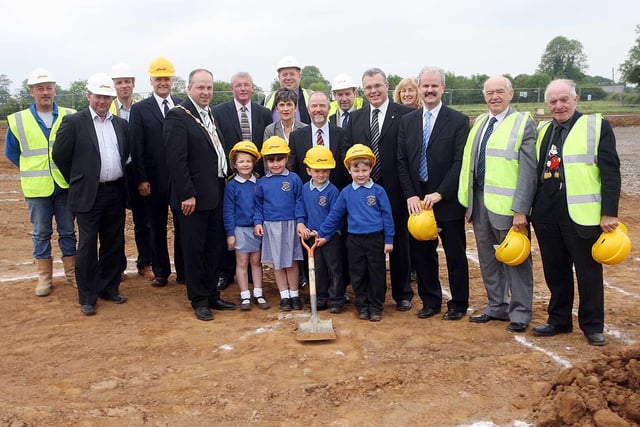 Ballinderry Primary School pupils Rachel Logan, Rebecca Hendron, Paul Wilson and Adam Black pictured with Lisburn Mayor James Tinsley, Stanton Sloan Chief Executive of the SEELB, Principal of Ballinderry PS Ian Thompson and Noel McKee Chairman of Ballinderry PS Board of Governors cutting the sod at Ballinderry Primary School's new site in 2008. Also pictured are members of Lisburn Council.