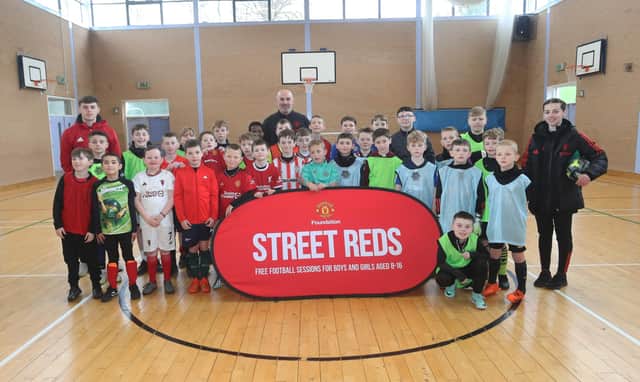 Some of tbe younger age group pictured with Manchester United Foundation's Stephen Parkhouse and Foundation coaches at the Easter tournament in Oakgrove College.