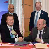 The TUV and Reform UK leaderships signing a pact earlier this year, which was fundamentally undermined by new leader Nigel Farage on Monday.