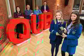 Katie O'Reilly of Rathmore Grammar (left) and Emma McNally of St Mary's Grammar (right) are presented with the 2023 NI Schools' Business Challenge winner's trophy as joint champions by event organisers (L-R) Laura Jackson, BDO NI Partner and Honorary Professor at Queen's Management School, Professor Ciaran Connolly of Queen's Management School, Jill Armer, Education Manager for Business Studies at CCEA and Billy Moore, Financial Director at Henderson Group.Pic: Brian Thompson