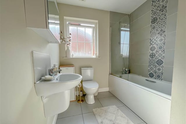 Family bathroom with white three piece suite.