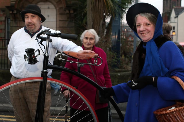 The great Mephisto with his Penny Farthing and Margaret Gordon in period costume draw the attention of a passer-by during the fair in 2012.