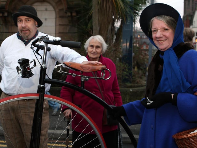 The great Mephisto with his Penny Farthing and Margaret Gordon in period costume draw the attention of a passer-by during the fair in 2012.