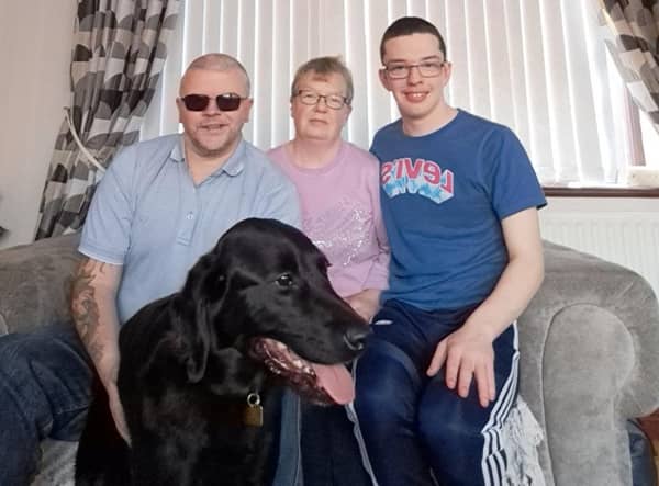 Portadown man Les Massey with his Guide Dog Munro, his wife Stephanie and his son Reece. Les is hoping for more volunteers for his Co Armagh Tail Blazers group which helps raise money for Guide Dogs NI.