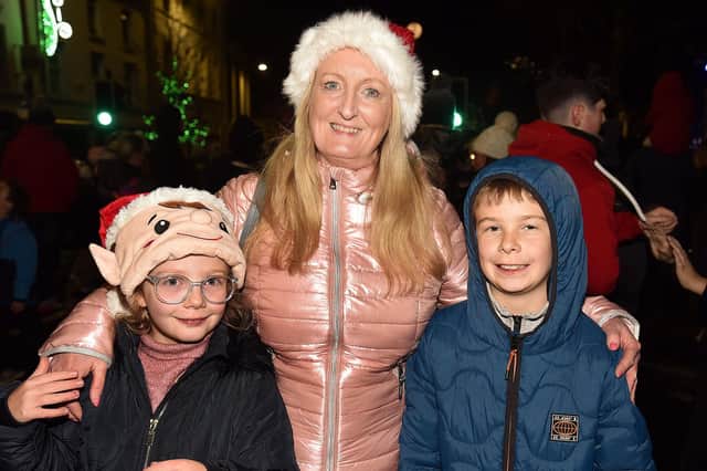Pictured at the Lurgan Christmas lights switch on Friday night are Isabella Rafferty (9) and Oliver Rafferty (10) with their auntie, Wendy McAllister. LM48-208.