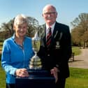 Famous faces at Portadown Golf Club, Ann Walker and Dave Allen posing with a famous trophy. PT14-308.