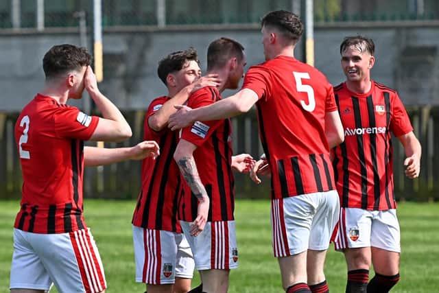 Teammates congratulate Michael McCavitt after he opened the scoring. ​