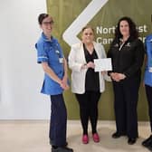 Sperrin Unit Staff Nurse Gillian Edgar and Staff Nurse Kamara McElhinney accept the kind donation from Ria and Susan Forgie.   Credit WHSCT