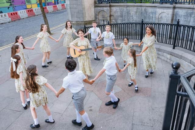 Anna Maria Boyle, who plays Maria, photographed singing Do Re Mi with all the Von Trapp children. Pic credit: Belfast Operatic