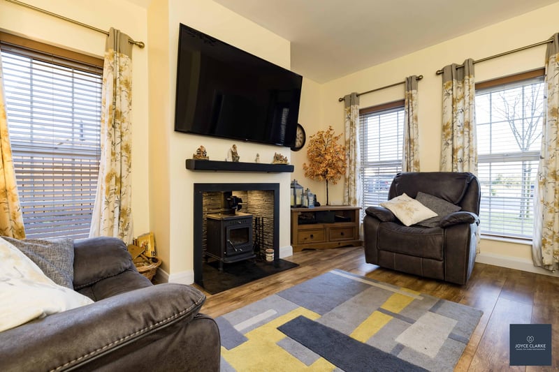 The attractive living room is the perfect place to relax in front of the wood-burning stove.