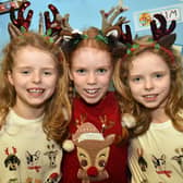 Getting into the Christmas spirit at The Cope Primary School, Loughgall, festive afternoon are, twins, Iris Parker (7), left, and Carmen Parker (7), right, and friend Cora Cregan. PT51-212.