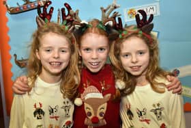 Getting into the Christmas spirit at The Cope Primary School, Loughgall, festive afternoon are, twins, Iris Parker (7), left, and Carmen Parker (7), right, and friend Cora Cregan. PT51-212.