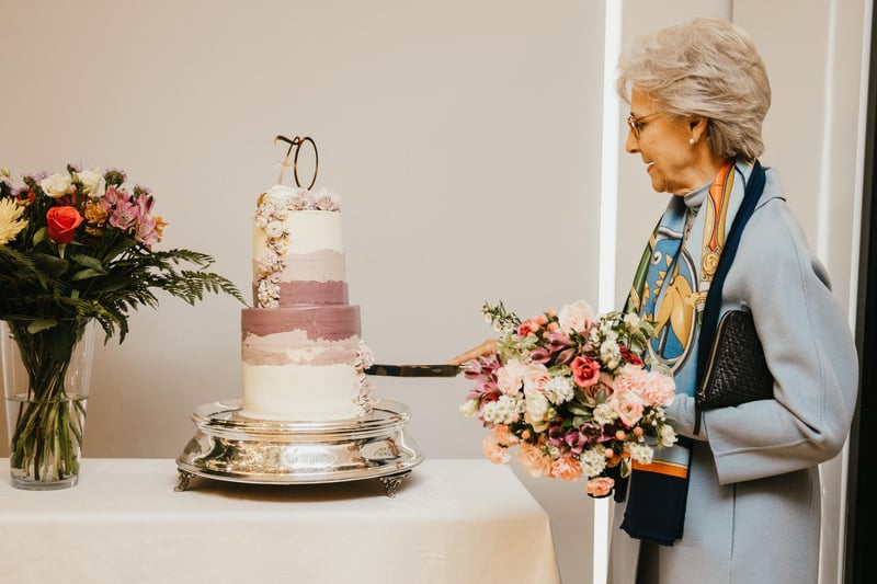 Her Royal Highness the Duchess of Gloucester cutting a 70th anniversary Cake as Alexanders celebrate 70 years in family business. Photo taken by Hannah McKeown Photography