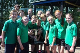 Carrick Cricket Club's 2015 Primary Schools' Cricket Tournament winners Greenisland Primary School are presented with their trophy by Club Chairman Jim Nelson, with teacher Mr. Best. INCT 24-012-JC  Photo: National World