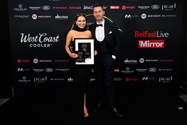 Holly-May Wilson, on behalf of Hair & Co, accepts the trophy for Hair Salon to Watch from Steven Dutklewicz – representing NI Beauty Excellence Awards event partner Davines