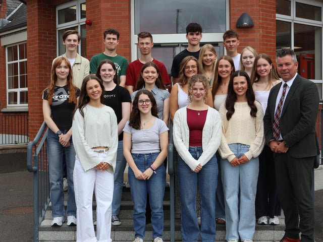 3 A Star A Grades students at Rainey Endowed School with their headmaster Mr Mark McCullough.