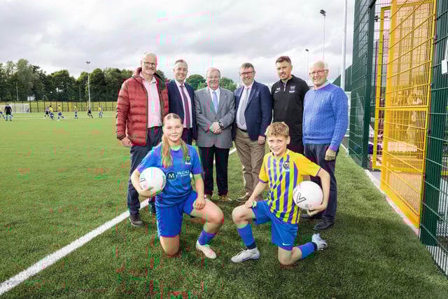 Councillor Tim Mitchell, Councillor Alan Givan and Mark Watson, Head of PE at Laurelhill Community College alongside school children