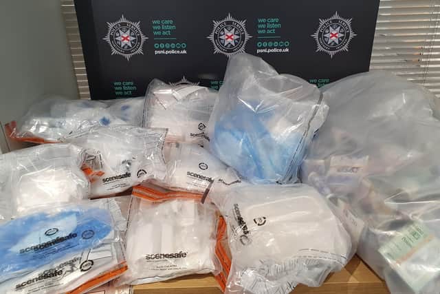 Some of the drugs, deal bags and cash seized during Thursday's searches in north Belfast and Glengormley. Picture:  PSNI