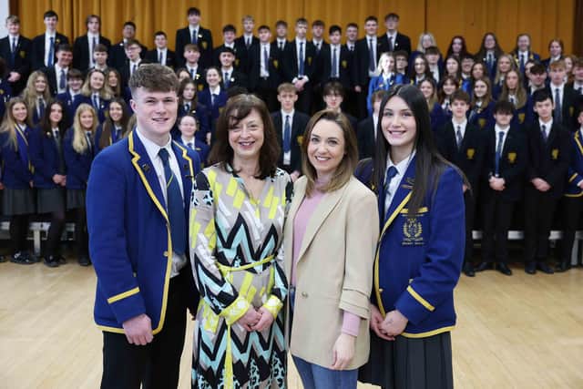 Amy Adair-McCourt (second left) and Charlotte Weir, principal of Belfast High School, are pictured with head girl, Amy French and head boy, Joel O'Rourke together with some of the other 100 Belfast High pupils set to get a potentially life-saving scan during Heart Month. Amy lost her brother, Nicky (Nick) Adair, a former Belfast High pupil, to SADS in March 2020 and since then has been passionate about letting as many people across Northern Ireland as possible know about the hidden dangers. Picture: Darren Kidd / Press Eye