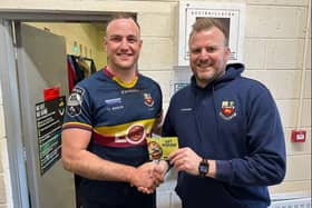 ​Alex Thompson receives the Karri Kitchen man-of-the-match award from Bann's Director of Rugby Marc Eadie after the side's game at Cashel.