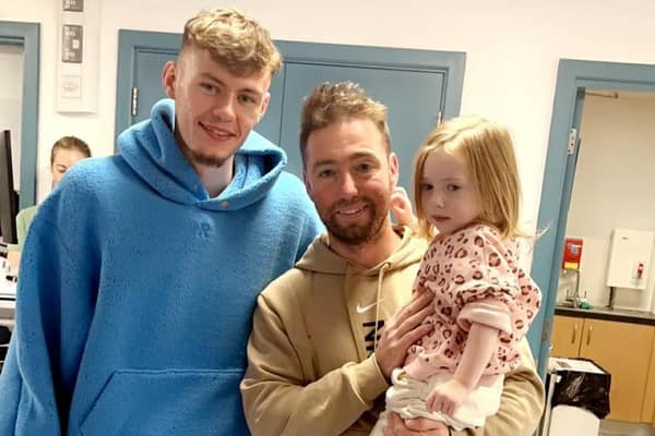 Liverpool and Northern Ireland player Conor Bradley with Gerard and Aurora O'Reilly at the Royal Belfast Hospital for Sick Children on November 19. (Pic: Contributed).