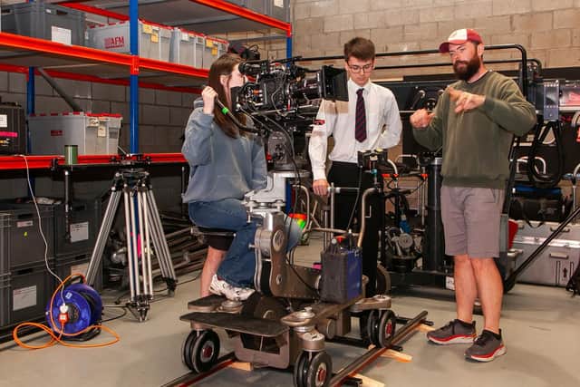 Northern Ireland film grip Donavan Gallagher pictured at Panavision Belfast with Cara from Friends School Lisburn and Aaron from Belfast Royal Academy learning how to work the equipment on a film set. Credit: Submitted