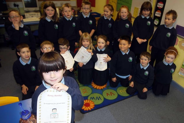 Ballycarrickmaddy Primary 3 pupil Christina Allison and the rest of her class pictured with money collected by pupils in 2008 to go towards the school fund