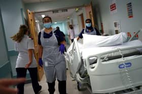 Medical staff transfer a patient along a corridor at the Royal Blackburn Teaching Hospital (Photo: HANNAH MCKAY/POOL/AFP via Getty Images)