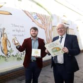 Councillor Aaron McIntyre and Alderman Allan Ewart get a look at the new Sam McBratney artwork in Haslem's Lane