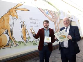 Councillor Aaron McIntyre and Alderman Allan Ewart get a look at the new Sam McBratney artwork in Haslem's Lane