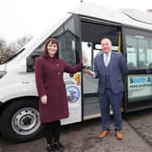 Former Infrastructure Minister Nichola Mallon with Tom McCarthy, manager of South Antrim Community Transport, after the introduction of first electric bus to the service in 2021.