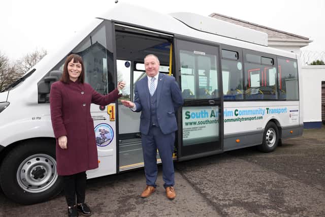 Former Infrastructure Minister Nichola Mallon with Tom McCarthy, manager of South Antrim Community Transport, after the introduction of first electric bus to the service in 2021.