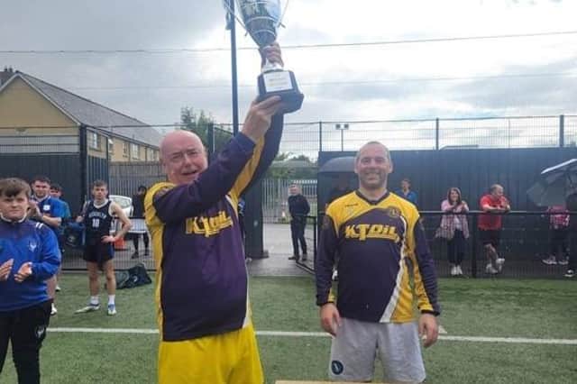 Angela Mc Cabe Cup Winners of 2023):	Meigh Rovers took the prize. Pictured here is Meigh Rovers Captain Paddy McCann lifting the cup with Frank McCabe who organised the event.