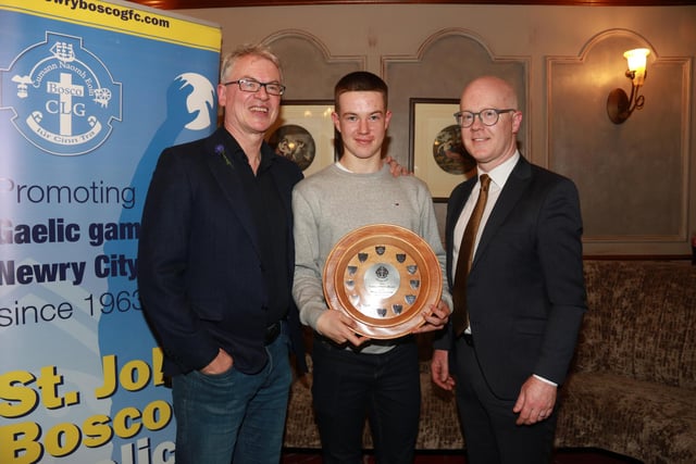Fionn McCaul Minor Player of the Year is presented with his award by guest Joe Brolly and Jack Devanney Chairman Down GAA. INNR4637