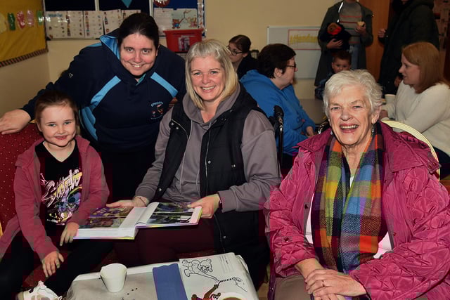 Looking back on photographic memories at the Epworth Playgroup 10th anniversary coffee morning are from left, Annie Stewart, Paula Whitla, playgroup assistant, Lynne Stewart and Mary Buckley. PT48-232.