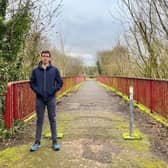 Alliance Party Cllr Robbie Alexander at the Moylinn footbridge, Craigavon, Co Armagh before it was dismantled. Work on its replacement is due to start next week.