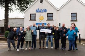 Power NI representative Barry Rogan pictured with the CEO of Share Discovery Village, Darragh Collins, and members of the new Unity in Motion dance and drama project.