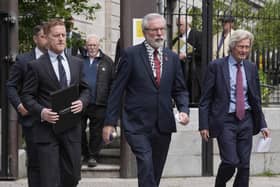 Former Sinn Fein president Gerry Adams (centre) outside the High Court in Dublin