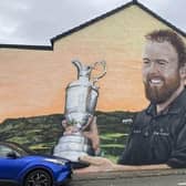Shane Lowry won the Claret Jug when The Open was last held in Portrush in 2019 - his win now commemorated in a mural in the town. Credit: NI World