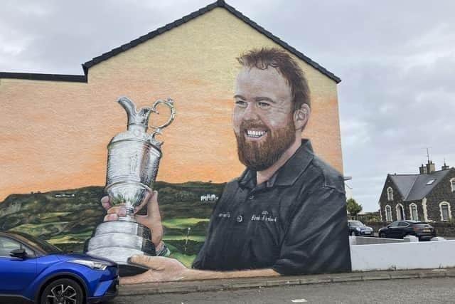 Shane Lowry won the Claret Jug when The Open was last held in Portrush in 2019 - his win now commemorated in a mural in the town. Credit: NI World