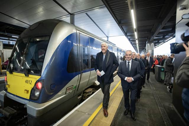 Infrastructure Minister John O'Dowd arrives on one of the first trains into Belfast Grand Central Station on Sunday morning and is welcomed by Translink Group Chief Executive Chris Conway. Picture: Brian Morrison