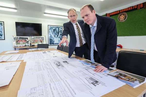 Communities Minister Gordon Lyons learning more about Carrick Rangers FC's development plans from chairman Peter Clarke. Photo: Department for Communities